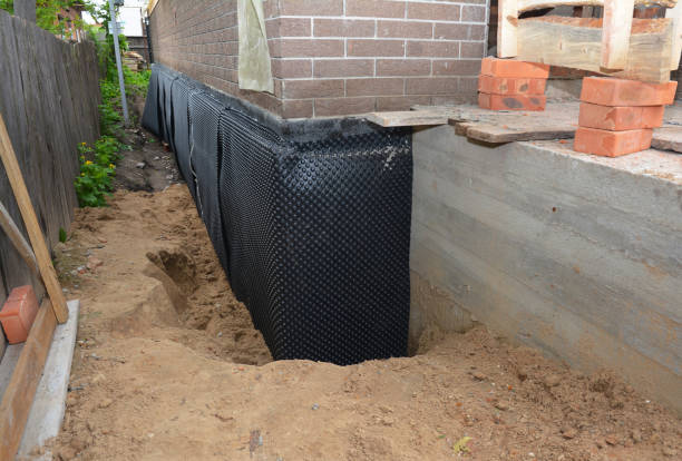 SJ Waterproofing Pros technician performing targeted Wet Basement Repair assessment in Hammond, IN
